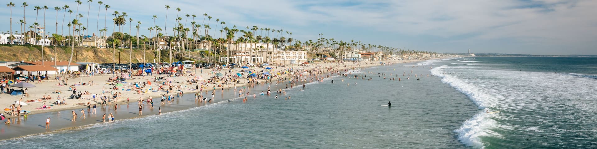 Waves in the Pacific Ocean and view of the beach from the pier i