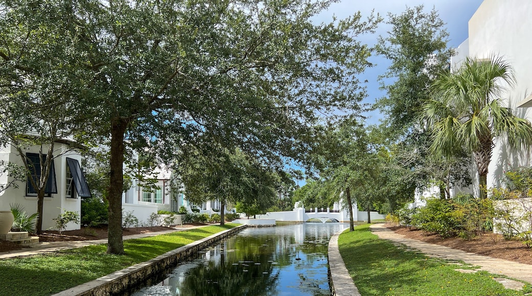 A walking path with water feature and homes in Alys Beach, Florida.