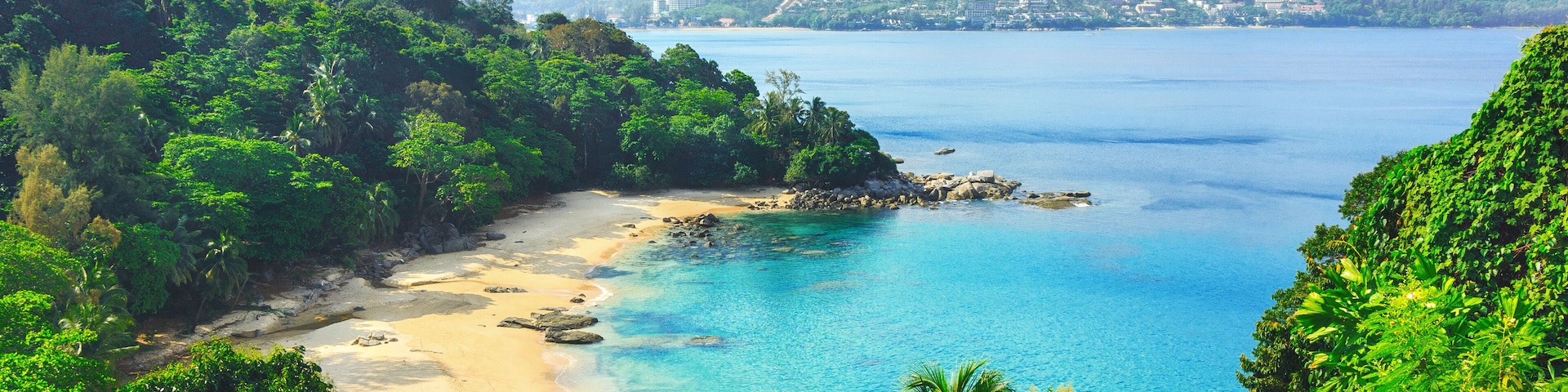 Picturesque view of Andaman sea in Phuket island, Thailand. View through the jungle on the beautiful bay and mountains. Tropical beach Laem Singh.