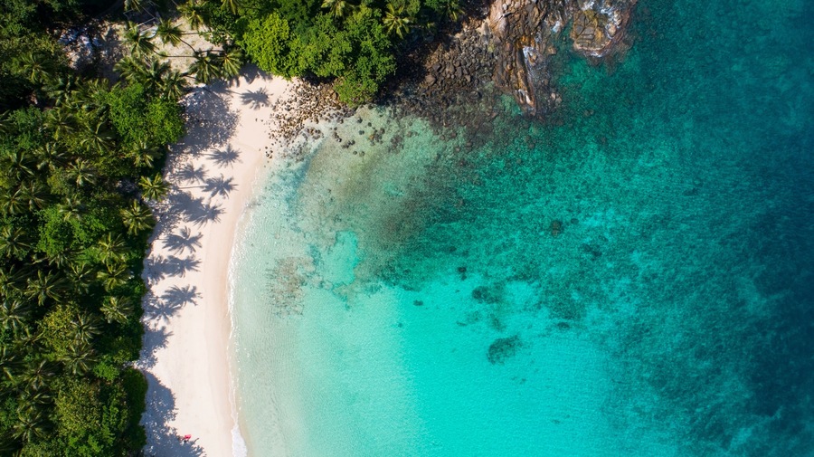 Amazing top view beach Aerial view of Tropical beach sea in the beautiful Phuket island Located at Freedom beach Phuket Thailand