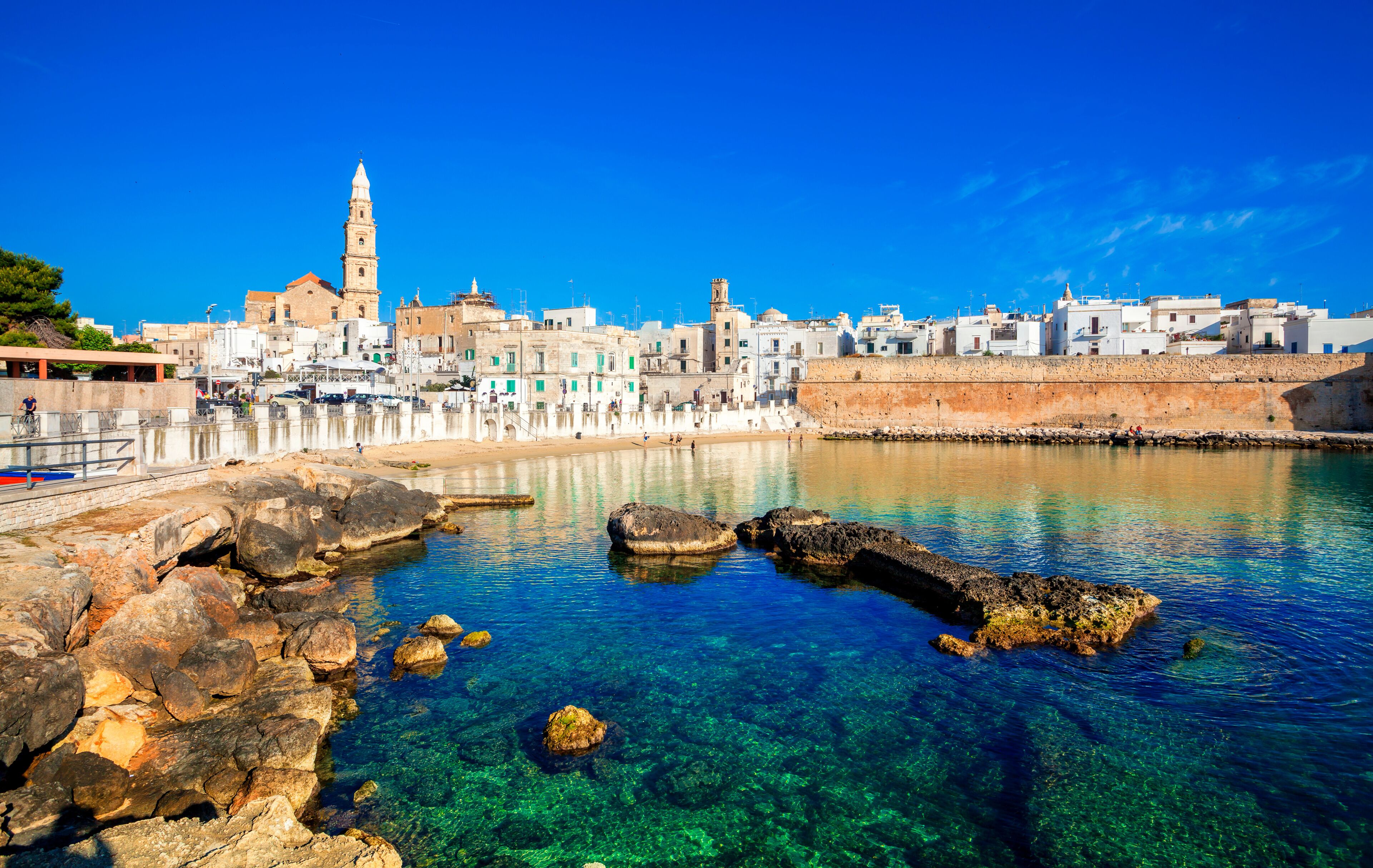 Panoramic view of Monopoli from the city beach of Cala Porta Vecchia, province of Bari, Puglia (Apulia), Italy, Europe. Monopoli seaside of Adriatic Sea, Puglia, Italy. Architecture of Monopoli