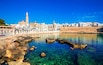 Panoramic view of Monopoli from the city beach of Cala Porta Vecchia, province of Bari, Puglia (Apulia), Italy, Europe. Monopoli seaside of Adriatic Sea, Puglia, Italy. Architecture of Monopoli