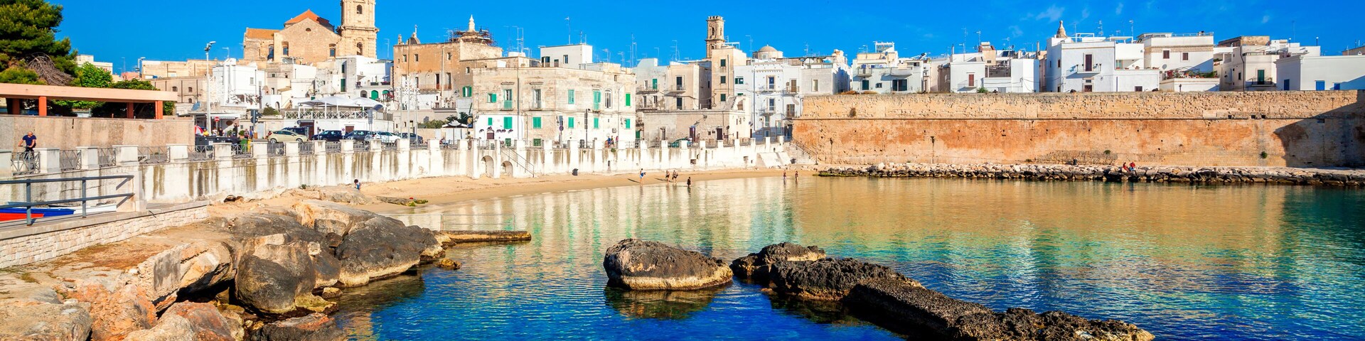 Panoramic view of Monopoli from the city beach of Cala Porta Vecchia, province of Bari, Puglia (Apulia), Italy, Europe. Monopoli seaside of Adriatic Sea, Puglia, Italy. Architecture of Monopoli