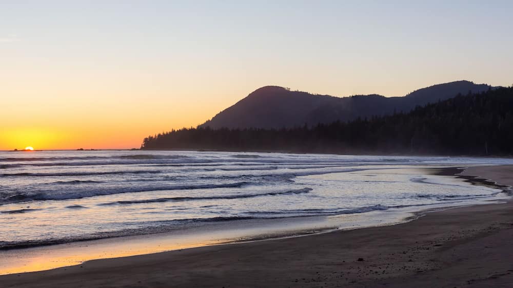 Beautiful sandy beach on the Pacific Ocean Coast during a vibrant summer sunset. Taken in Raft Cove Provincial Park, Northern Vancouver Island, BC, Canada.