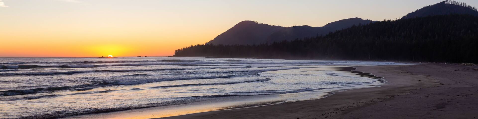 Beautiful sandy beach on the Pacific Ocean Coast during a vibrant summer sunset. Taken in Raft Cove Provincial Park, Northern Vancouver Island, BC, Canada.