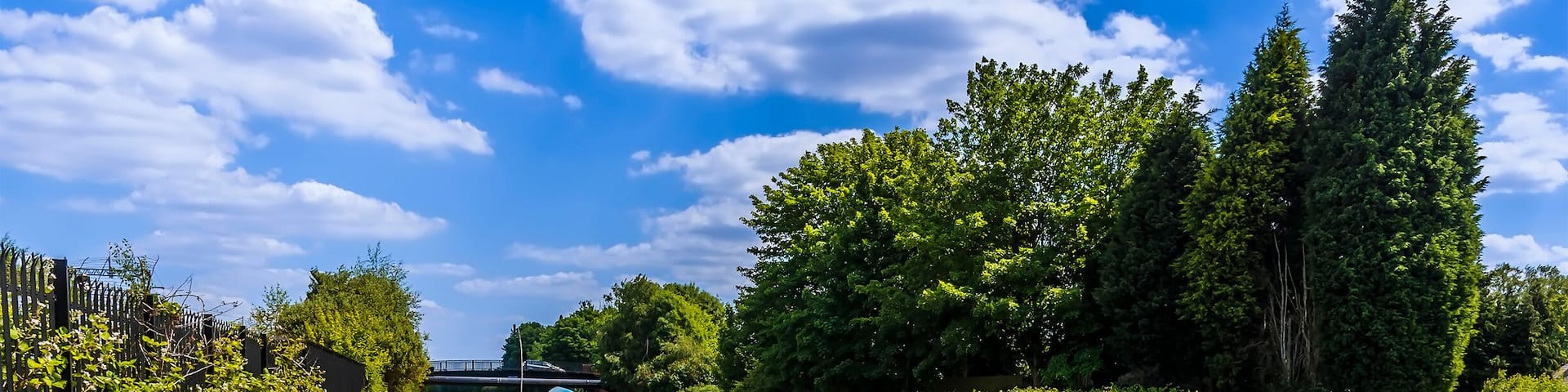 Narrowboats moored on the Birmingham Canal at Tipton in summertime