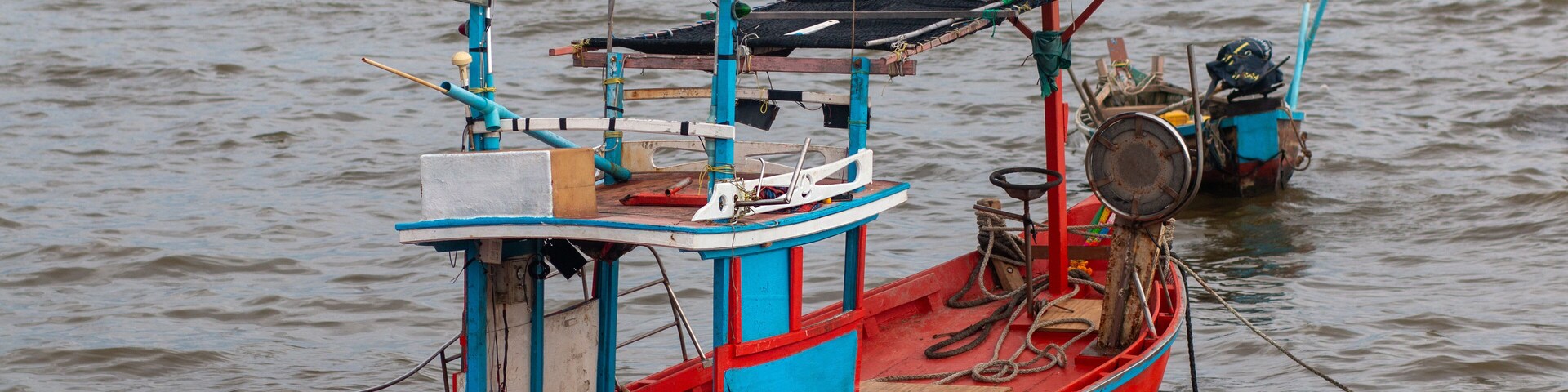 Small fishing boats at Wonnapa Beach, Bangsaen, Chonburi, Thailand.