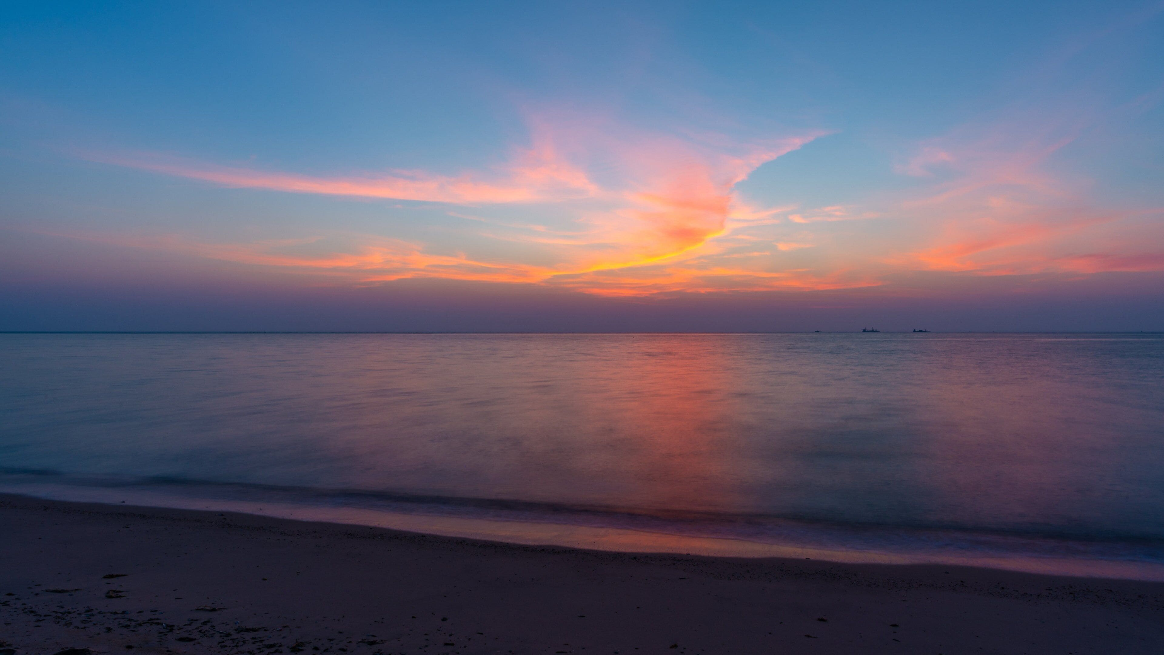 Al Wakrah Beach which includes a beach, a sunset and general coastal views