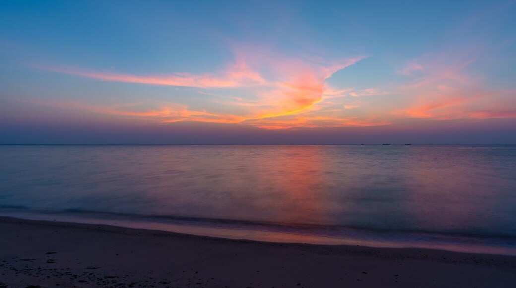 Al Wakrah Beach which includes a beach, a sunset and general coastal views