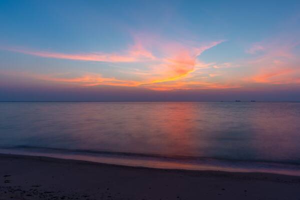 Al Wakrah Beach which includes a beach, a sunset and general coastal views