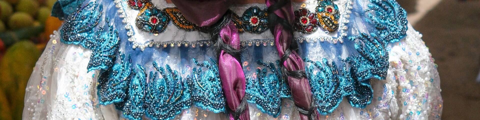 Santa Cruz del Quiche, Guatemala - July 6, 2025: A woman in traditional dress walks through the weekly market in Santa Cruz del Quiche, Guatemala.