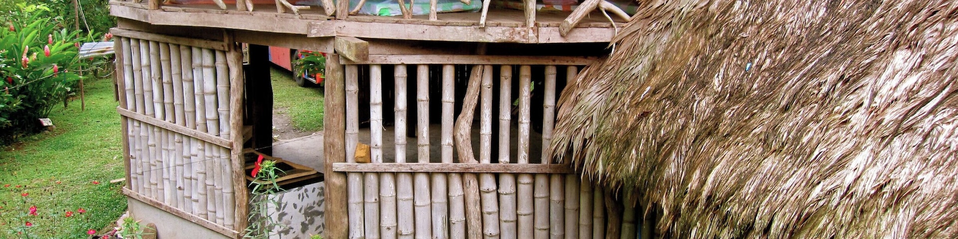 The conical houses at Bribri in Talamanca.
Sign on the road says Ditsowou "Encuentro de Culturas"
You can sleep in the house in the open air and learn about the native culture here along the river.