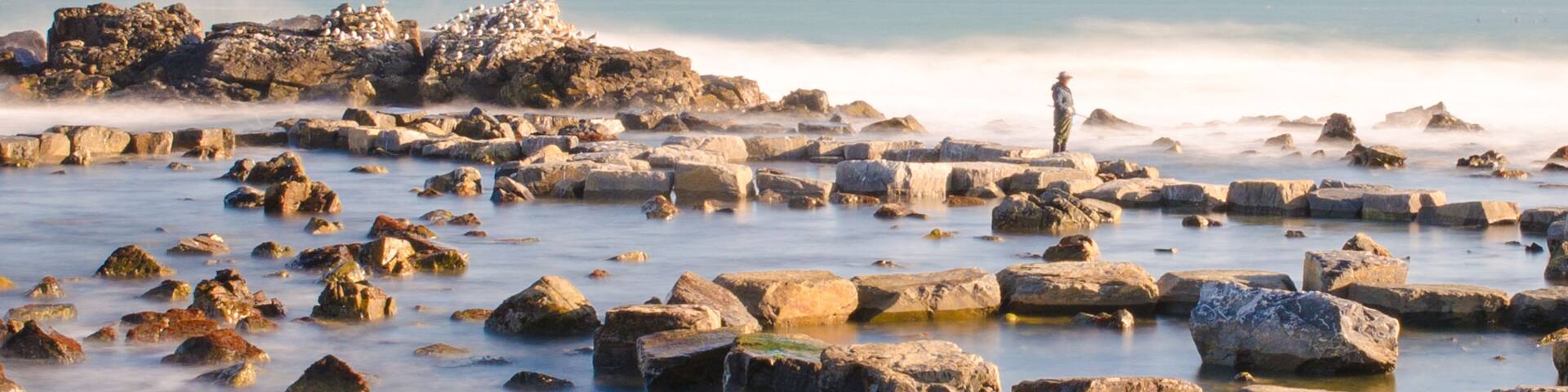 A fisherman was catching his time on the beach. And I watched him and took this calm picture.