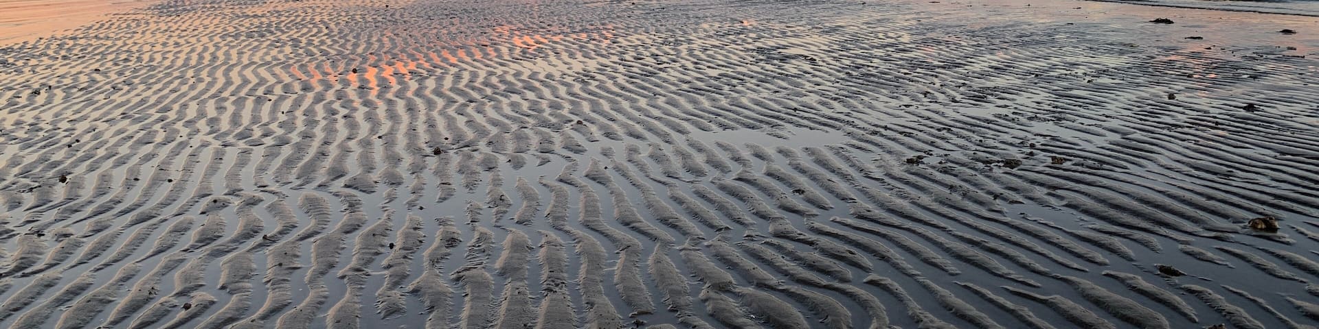 Sunset looking East from Stratford CT over the sands of lowtide and Long Island Sound