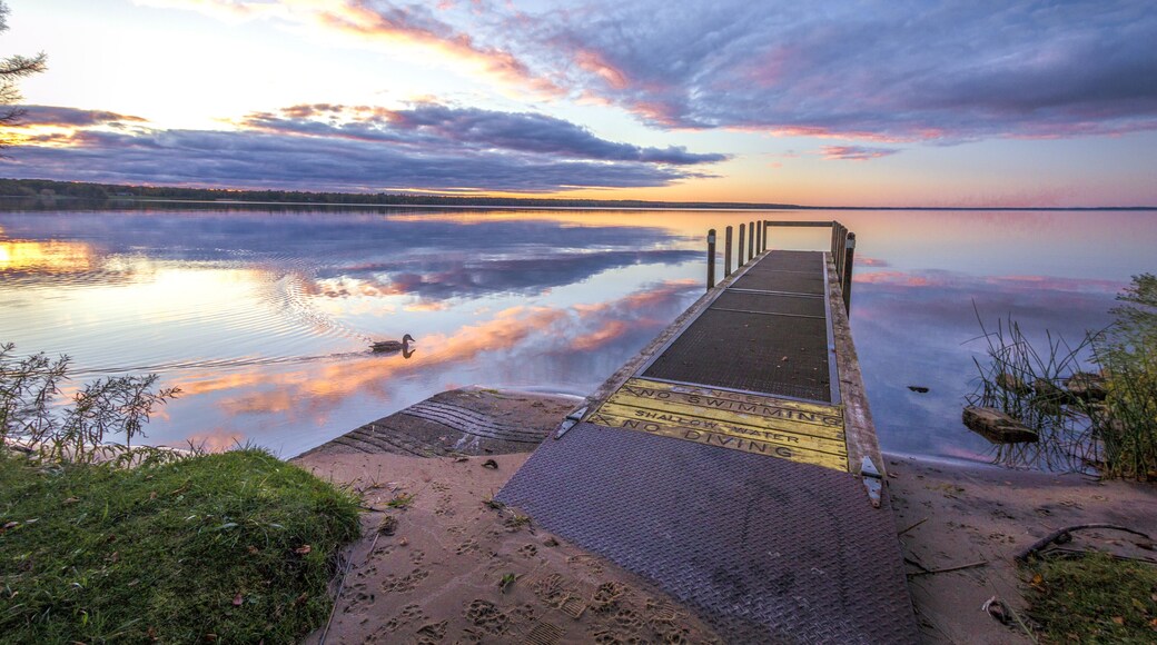 Summer At The Lake. Beautiful sunset reflected in the clean waters of Indian Lake State Park in the Upper Peninsula of Michigan.