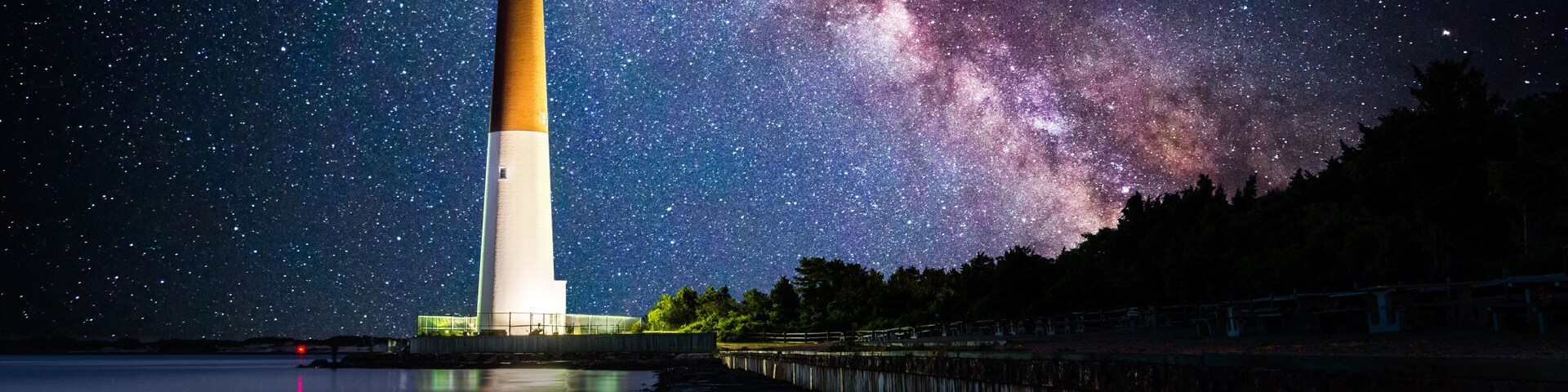 Barnegat Lighthouse under a starry night. Barnegat Lighthouse is a historic lighthouse located in Barnegat Lighthouse State Park in New Jersey