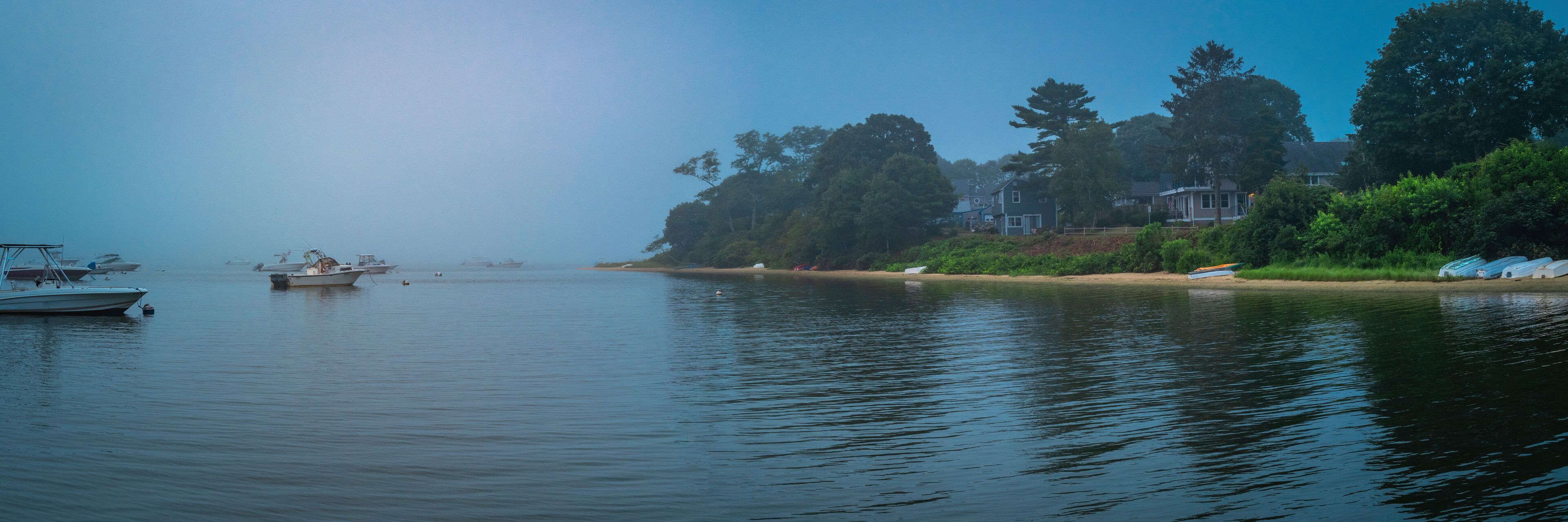 Foggy morning sunrise seascape at the Green Pond marina village in Falmouth on Cape Cod, Massachusetts.