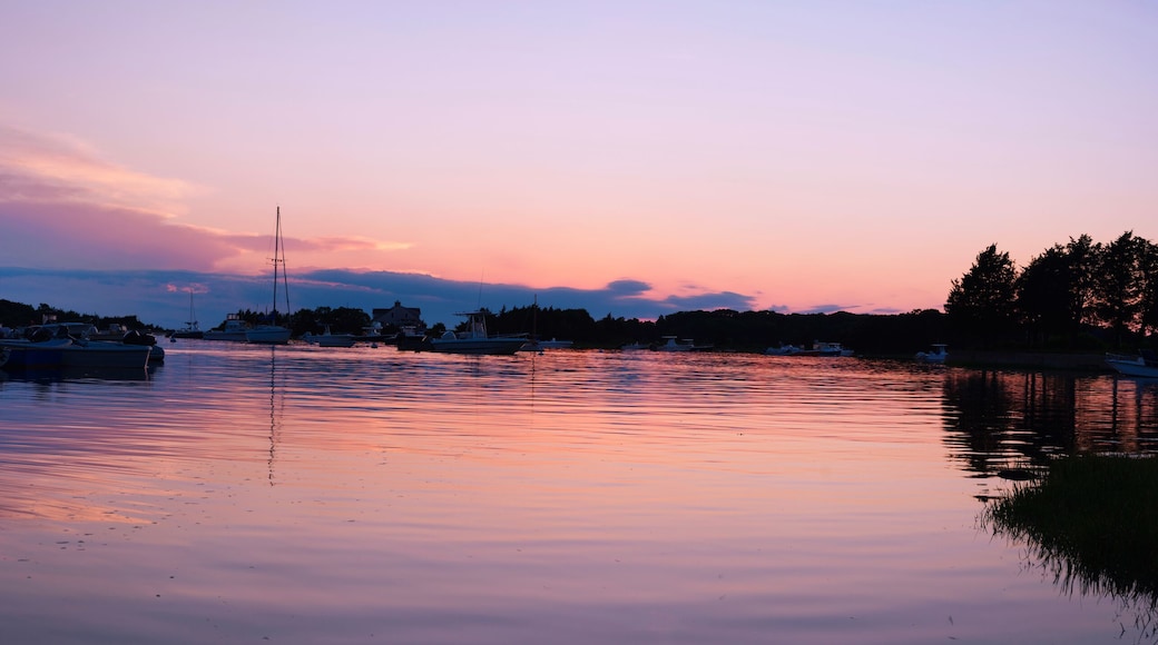 Cape Cod Sunrise Seascape Panorama at Quissett Harbor in Falmouth, Massachusetts, USA, a tranquil twilight coastal beauty with moored boats under warm pink dawn break