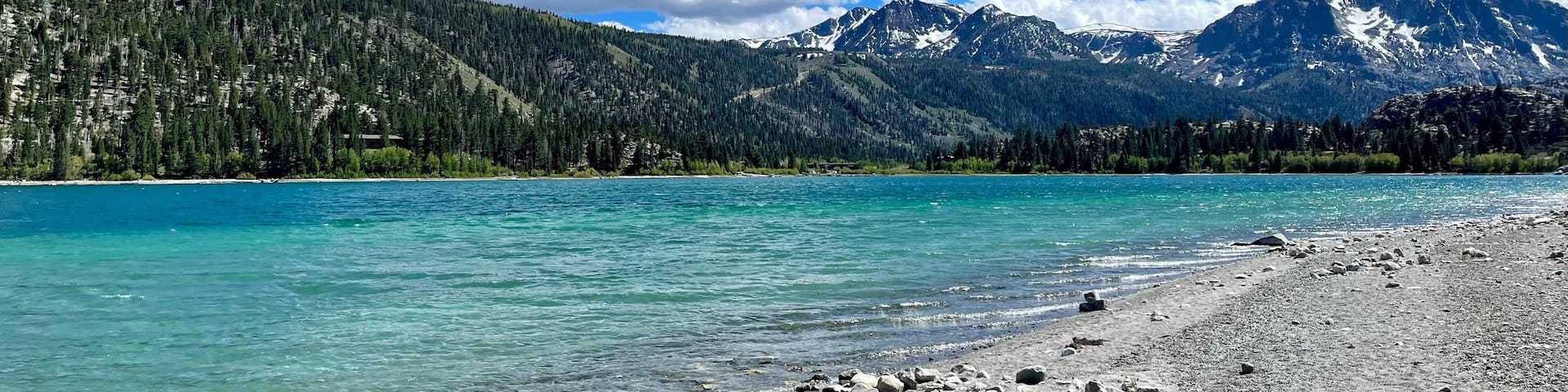 June Lake against a background of mountains and sky in the daylight in California, USA
