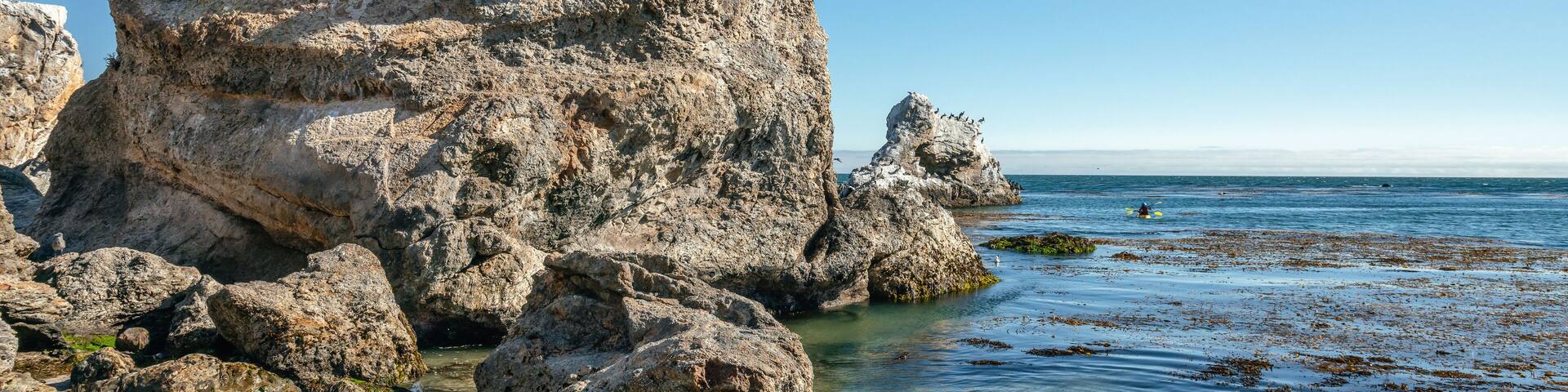 Sea kayaking. Exploring caves, arches, and rocks at Pismo Beach, California