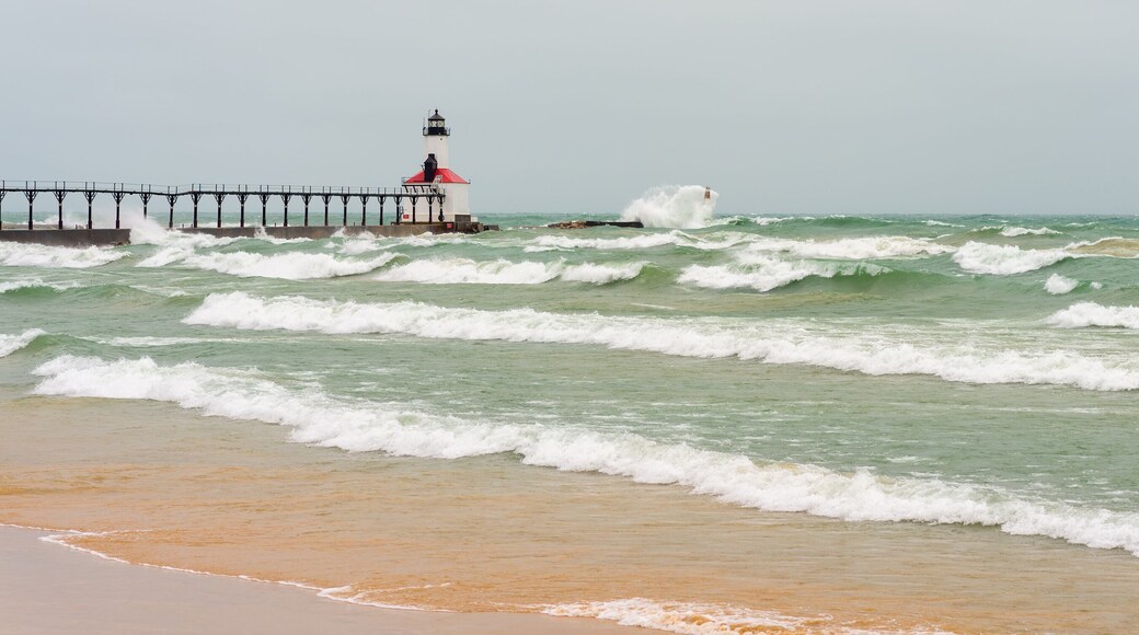 Lake Michigan waves crash against the East Pierhead Outer Lighthouse and catwalk, in Michigan City, Indiana.