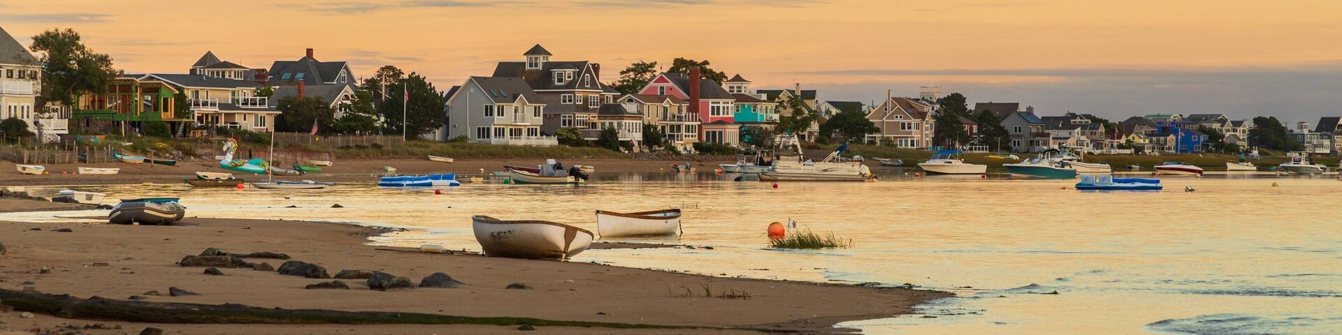 Plum Island Beach which includes a sunset, a sandy beach and a coastal town