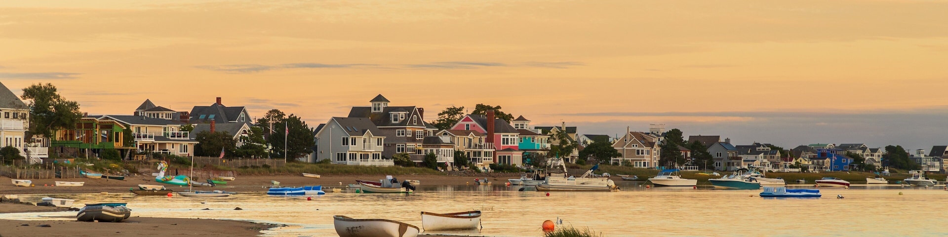 Plum Island Beach which includes a sunset, a sandy beach and a coastal town
