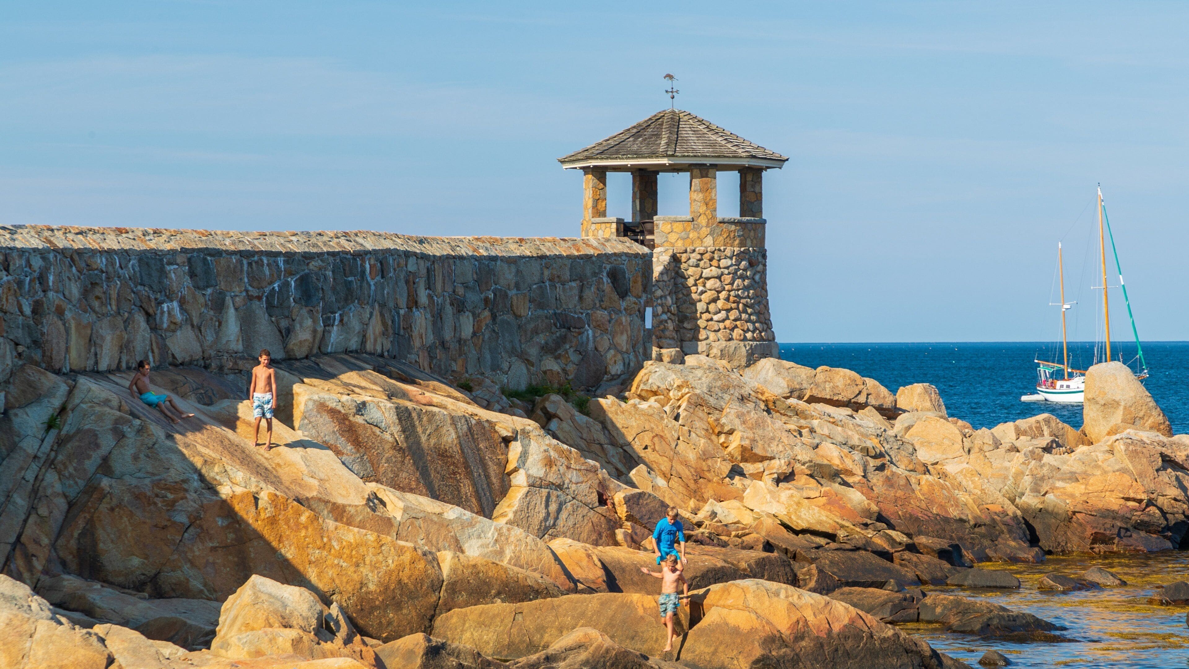 Front Beach which includes rocky coastline and general coastal views