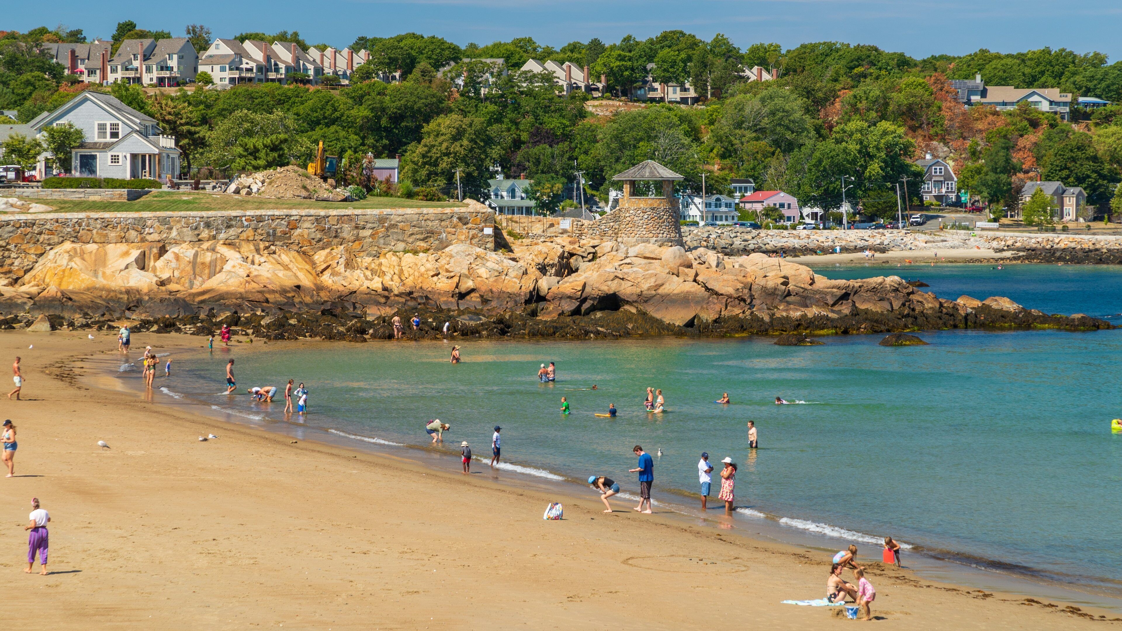 Front Beach which includes a coastal town, a beach and rocky coastline