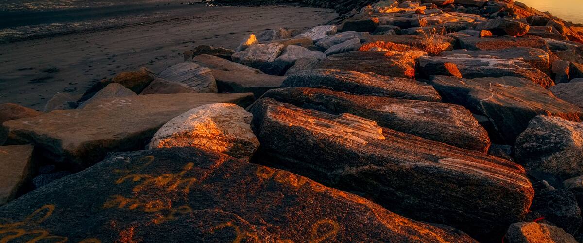 Sunset on the Breakwater at Seaside Park in Bridgeport, Connecticut, USA.