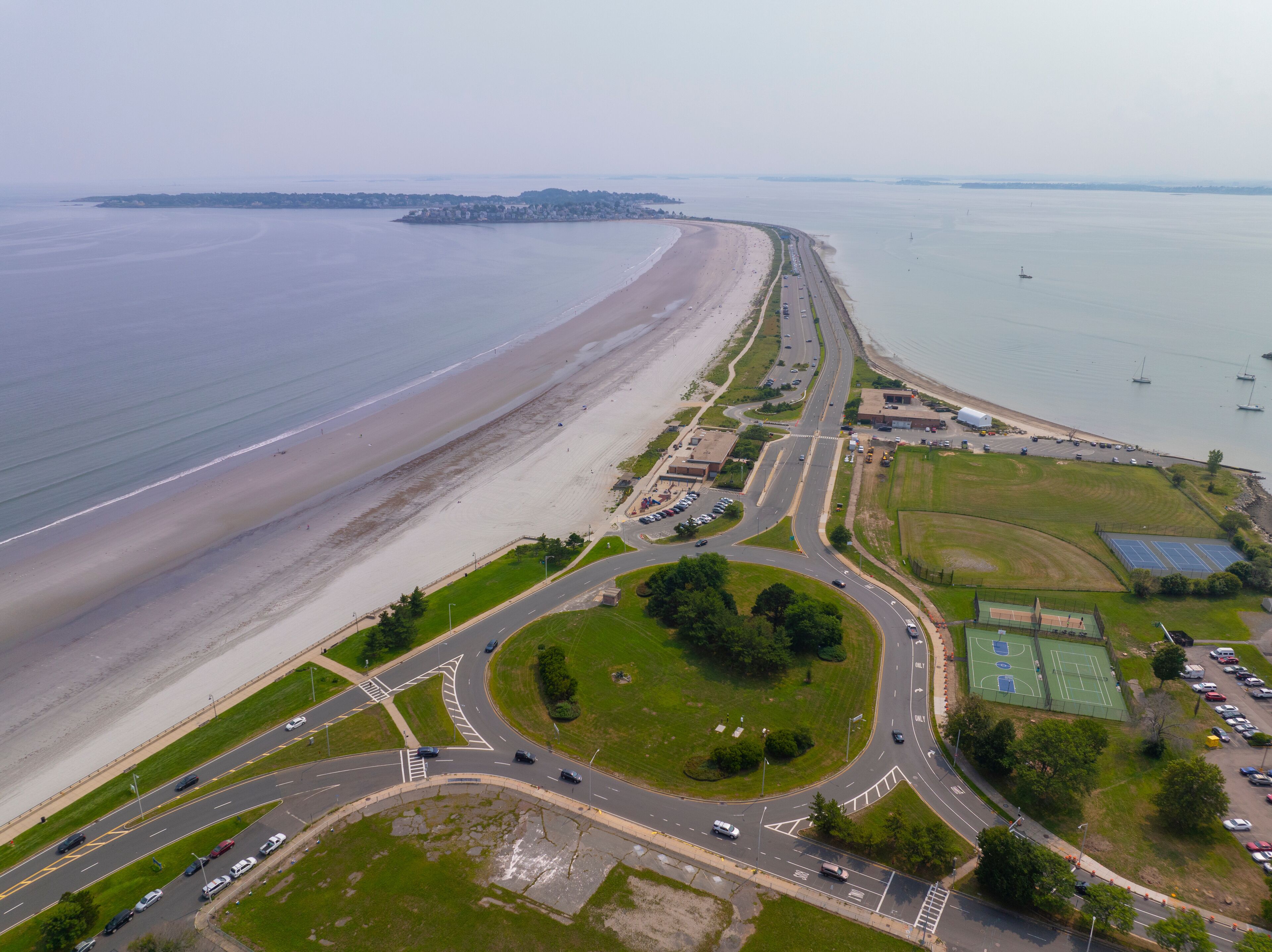 Nahant Long Beach and Nahant Road aerial view at Massachusetts Bay, with Boston modern city at the background, in town of Nahant, Essex County, Massachusetts MA, USA. 