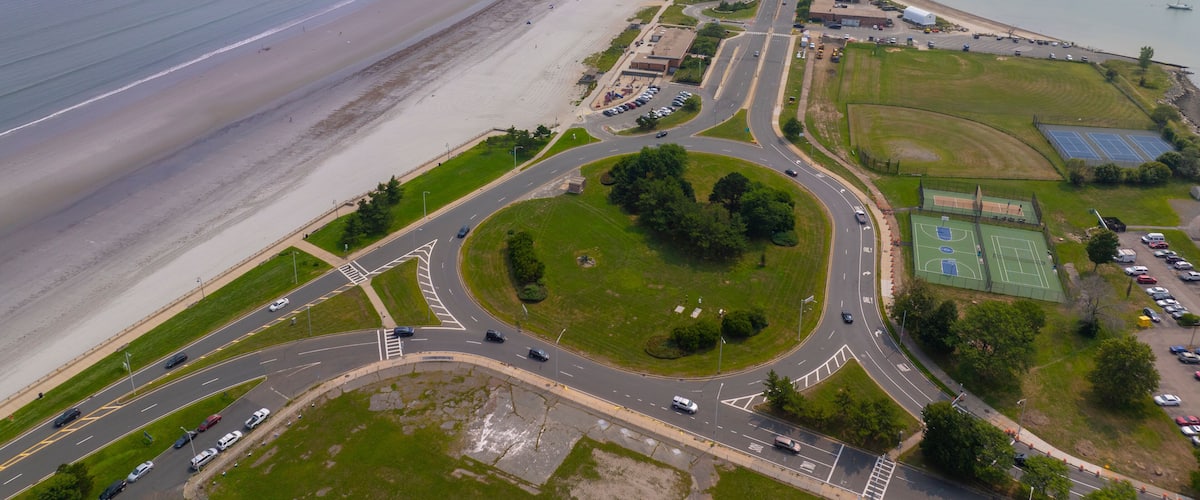Nahant Long Beach and Nahant Road aerial view at Massachusetts Bay, with Boston modern city at the background, in town of Nahant, Essex County, Massachusetts MA, USA.
