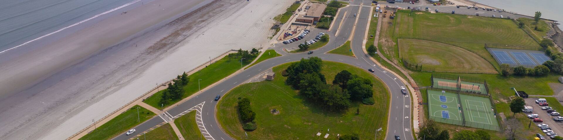 Nahant Long Beach and Nahant Road aerial view at Massachusetts Bay, with Boston modern city at the background, in town of Nahant, Essex County, Massachusetts MA, USA.