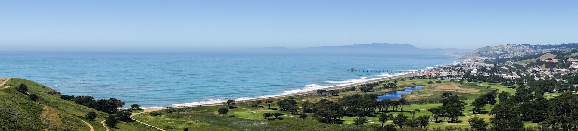 Panoramic view of Pacifica coastline as seen from the top of Mori Point, Marin County in the background, California