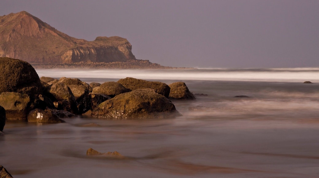Down on the beach at Cayton Bay just south of Scarborough North Yorkshire (UK) behind the large outcrop is Scarborough..The tide was just rolling on as the photograph was taken..a great place to walk along the wide open beach.
