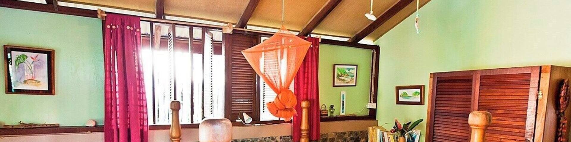 What a cute room - so sad we only stayed a week :) Each of the six rooms in this charming little B&B is unique and full of character. Iris and her team are wonderful hosts, and can set you up with local tours and activities.
The breakfasts are great, and the dinners are even better - think local ingredients and traditional recipes.
It's located a few miles outside town in the beautiful Roseau Valley, so you'll need transport of some kind - but that's true pretty much anywhere you stay on Dominica. Your best bet is to hire a car and driver for day trips to the nearby waterfalls, sulfur springs, and hiking trails.