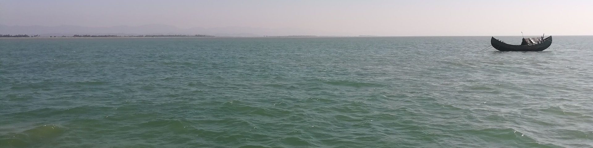 Lone boat floats on sea.