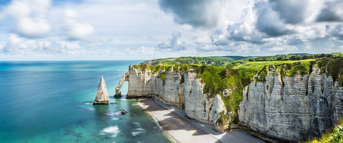 A coastal cliff with a clear view of the ocean.