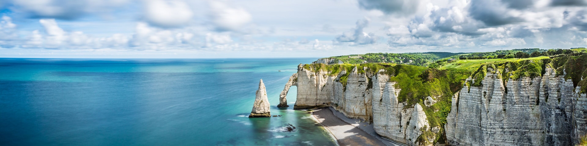 A coastal cliff with a clear view of the ocean.