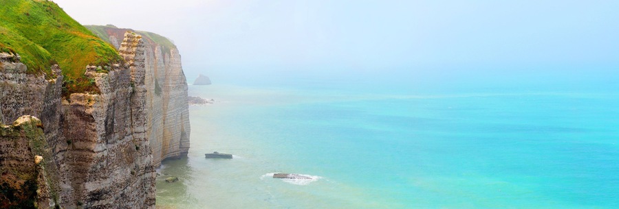 Picturesque panoramic landscape of famous natural cliffs Etretat, Normandy, France. Coast of the Pays de Caux area, sunny summer day