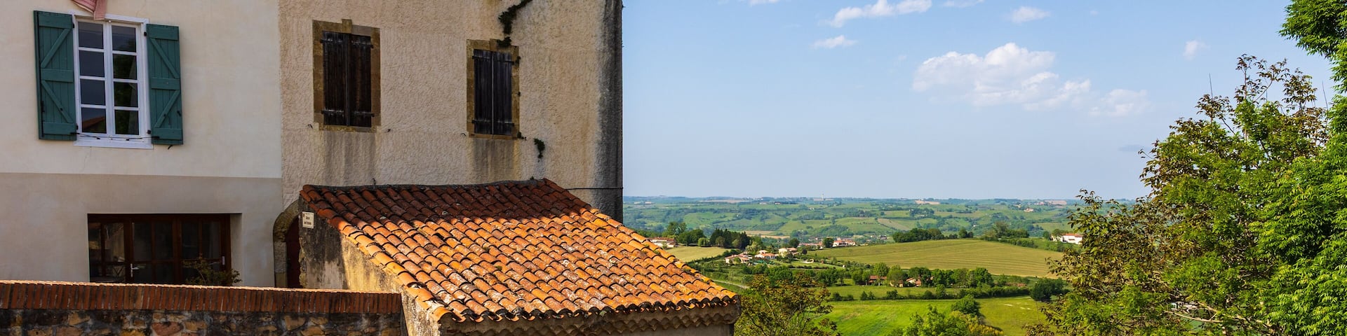 Agricultural landscape of hills in the valley of the Lèze from an alley in the village of Carla-Bayle