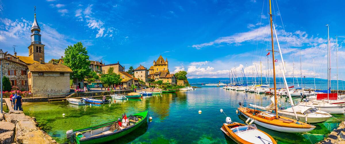A harbor with boats, a church, and a tower.
