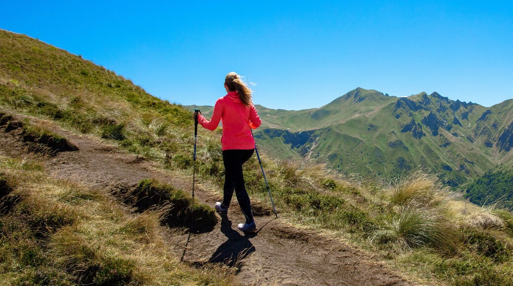 Hiker woman walking to the top of mountain- Puy de Sancy, Auvergne in France