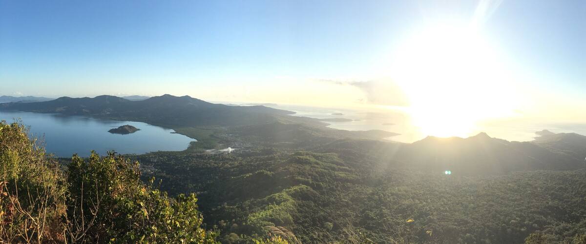 A mountainous landscape with a lake and a clear sky.
