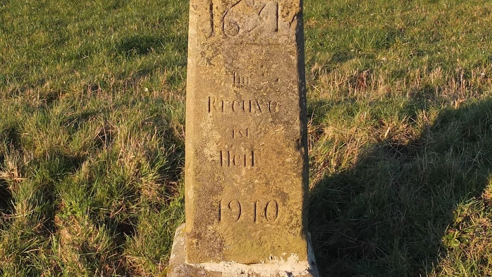 Wayside cross near Osweiler, Luxembourg, Inscription: "1631 - Im Kreuze ist Heil", restoration dated 1910.