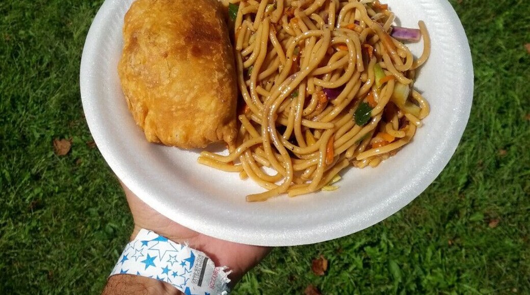 A pawpaw curry puff stuffed with potatoes and a side of noodles with veggies and pawpaw.