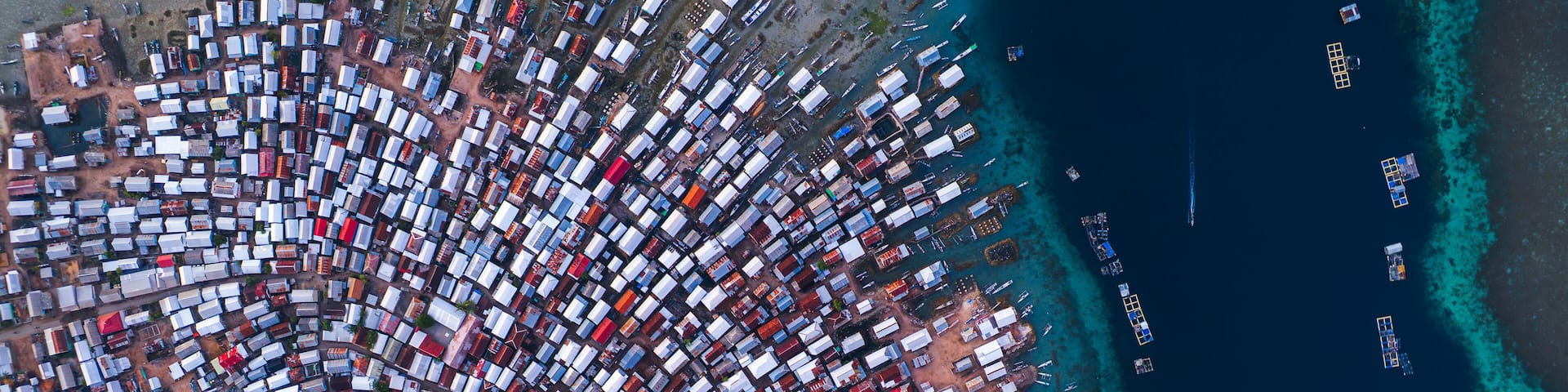 An aerial view of a densely packed port with numerous cargo containers and ships.