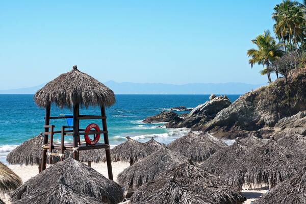 Palapas and guard tower on Playa las Estacas in Puerto Vallarta, Mexico