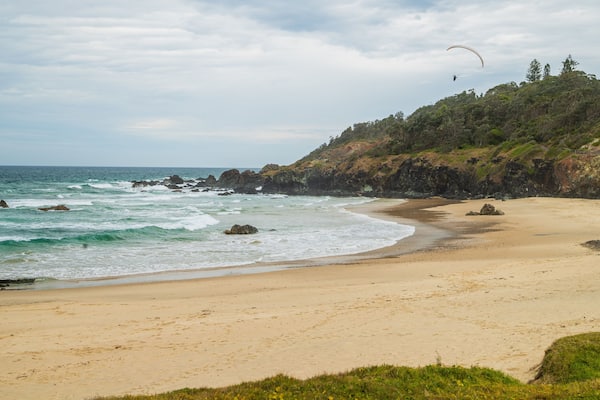 Oxley Beach which includes a beach and general coastal views