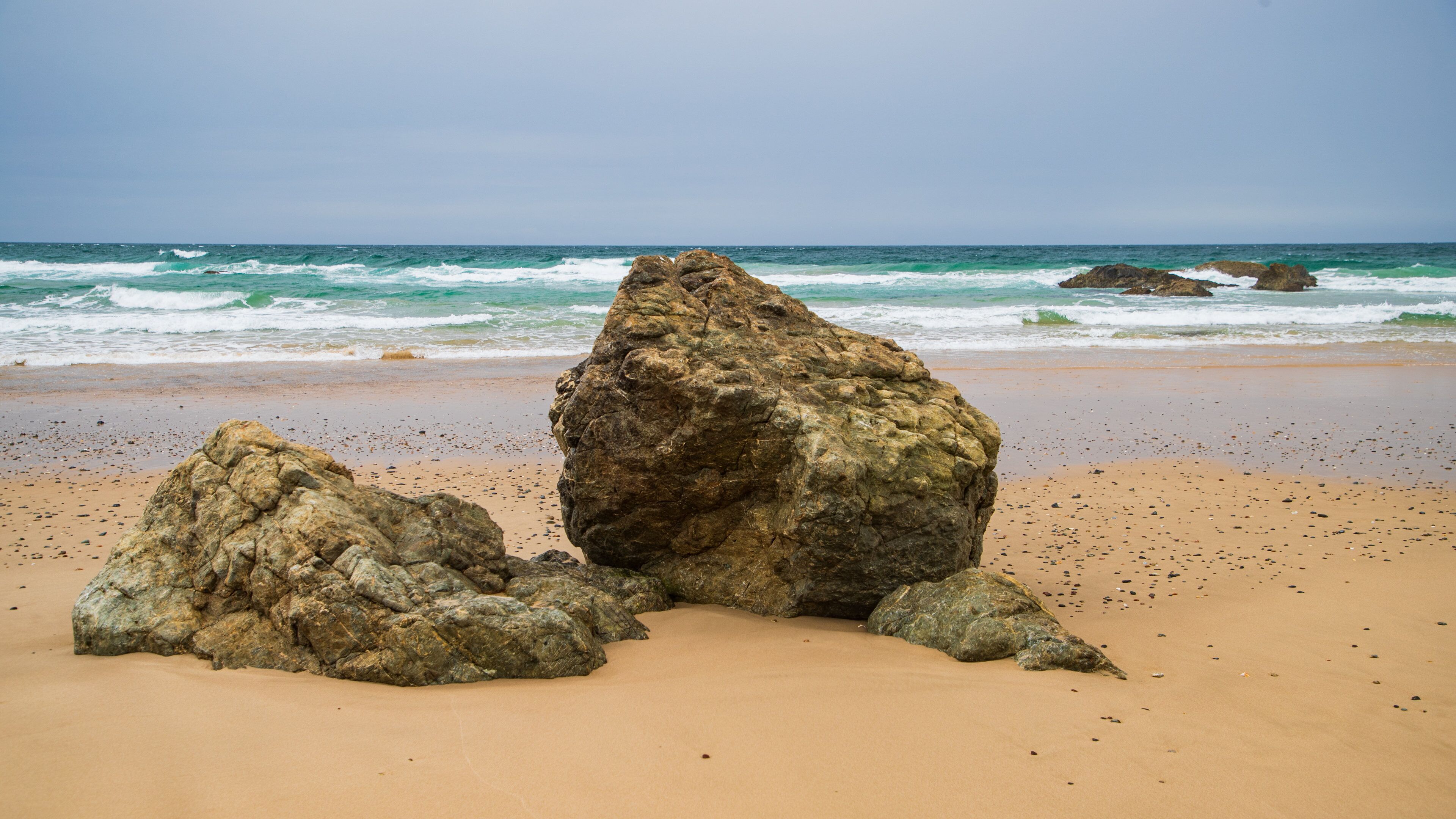Oxley Beach which includes general coastal views, rocky coastline and a sandy beach